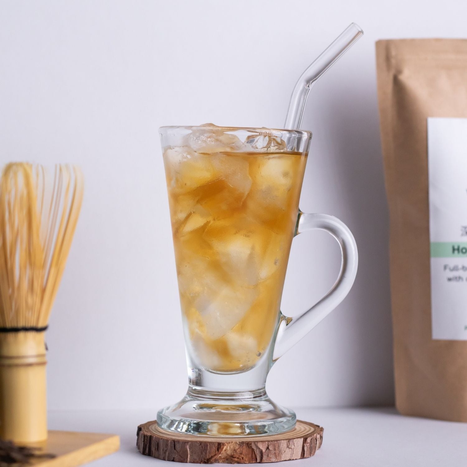 Refreshing iced Hojicha tea made from premium loose leaf tea produced in Kyoto, served in a tall glass with ice cubes