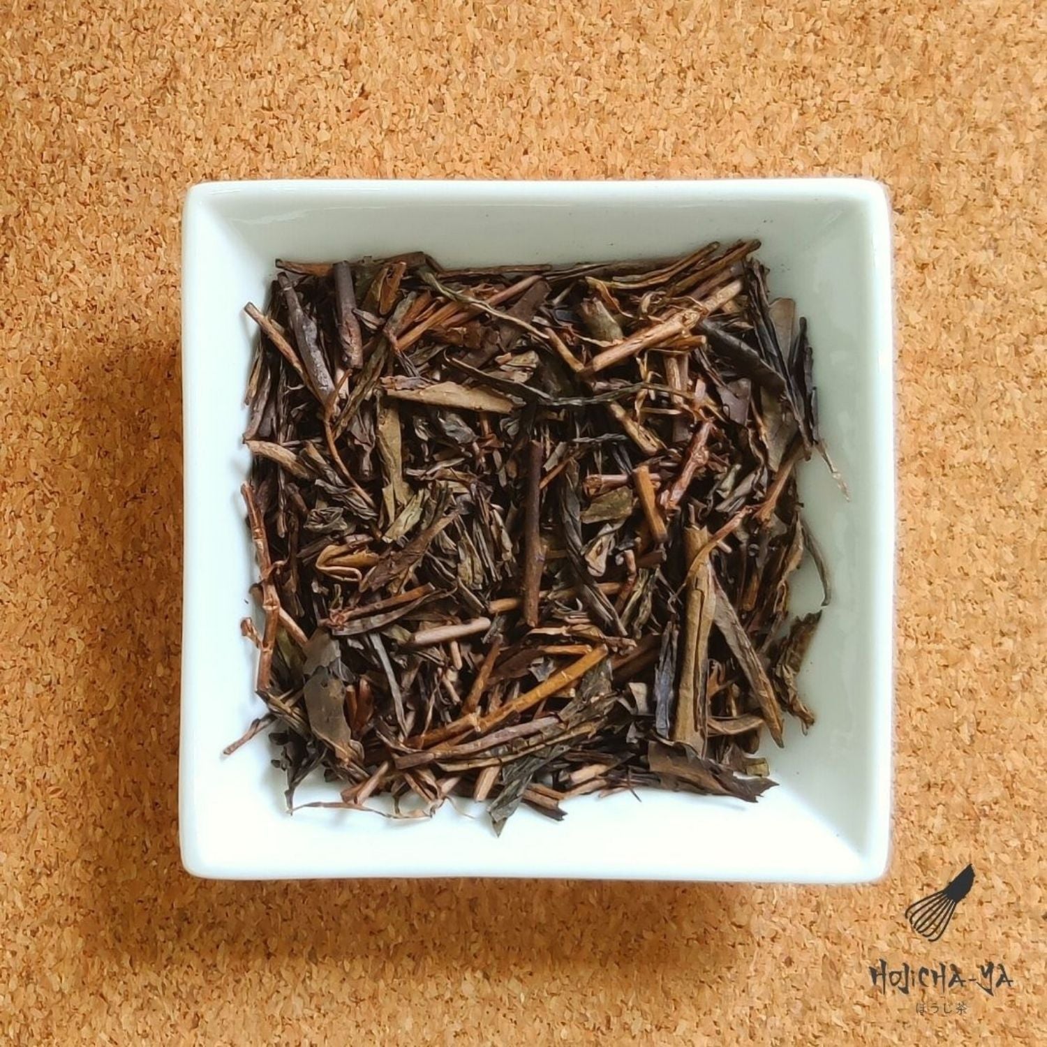 Loose leaf Hojicha tea, beautifully arranged in a dish, premium roasted Japanese green tea