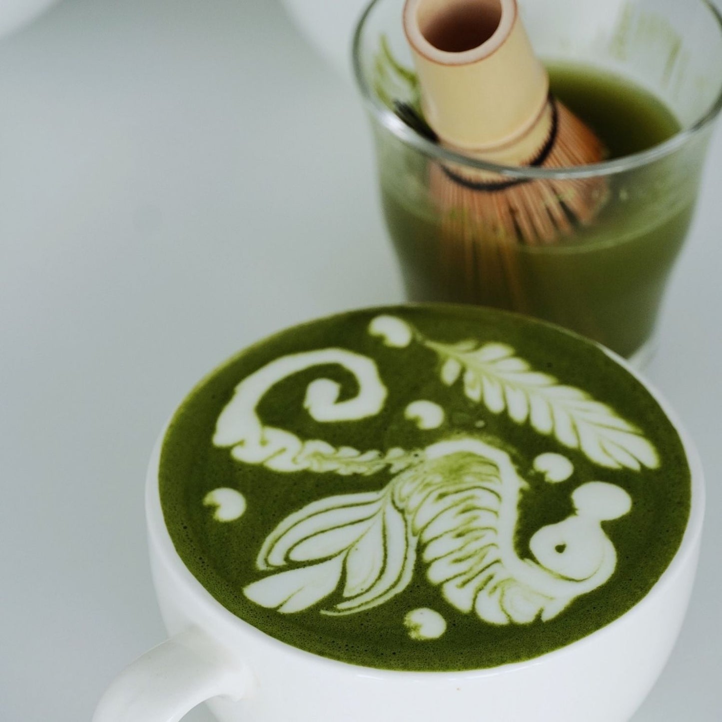 Premium Japanese green tea powder with traditional bamboo whisk, perfect for modern latte art in Malaysia