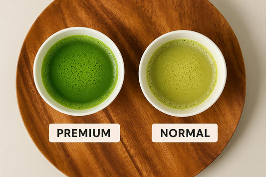 Overhead view comparing a bright premium matcha bowl with a dull normal matcha bowl on a wooden tray.